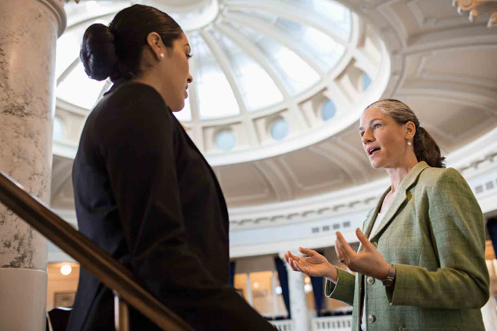 Innovations and Trends in Public Administration graduate certificate online two public administrators having a conversation in a large building